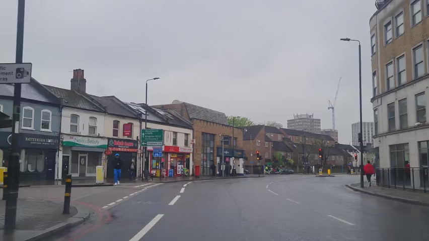 Dash cam POV footage from a windshield of a car driving through streets of London